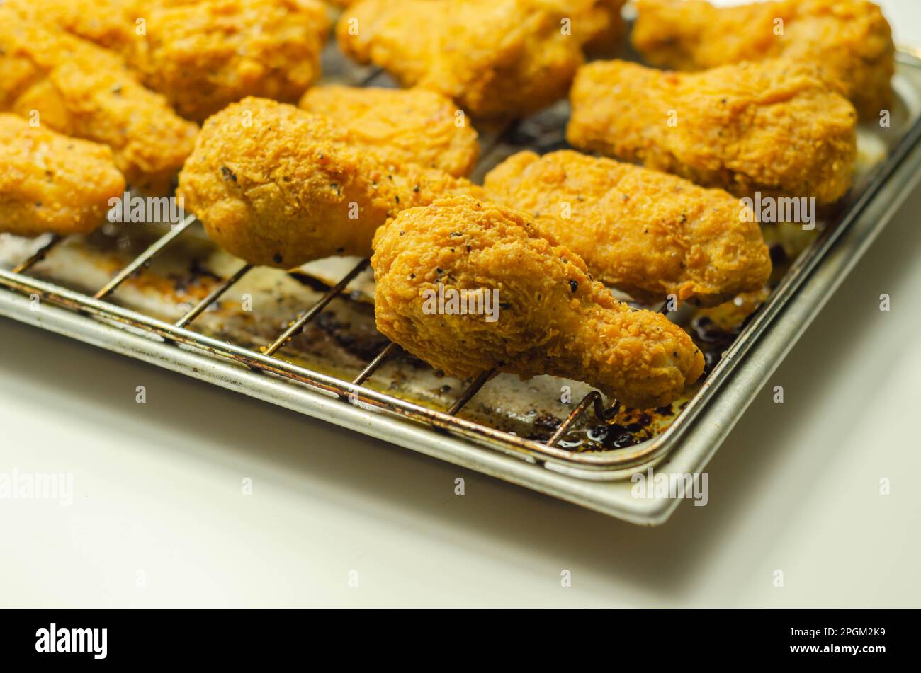 Southern crispy battered fried chicken wings, deepfried chicken wings on the metal tray, fast