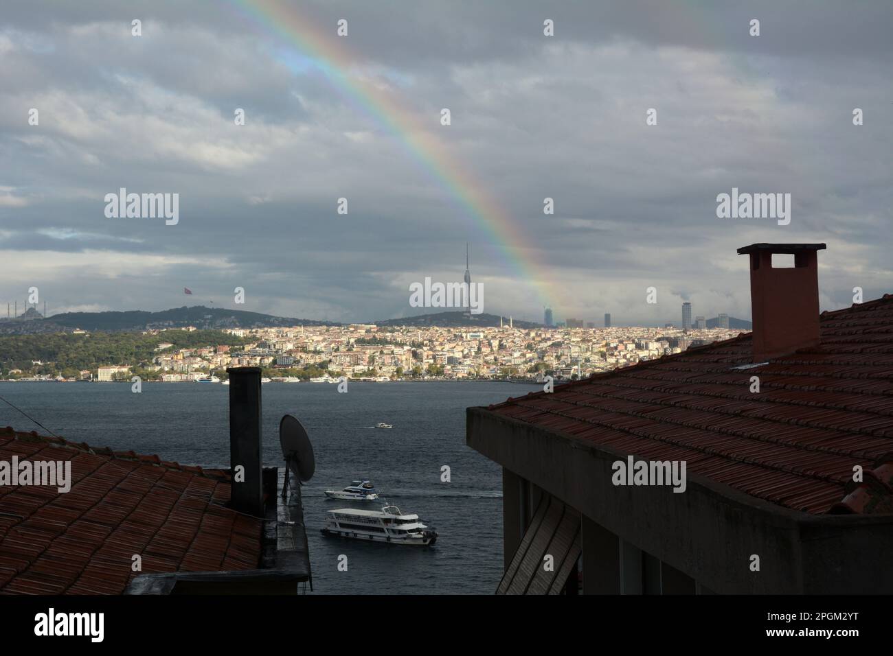 Looking at a rainbow across the Strait of Bosphorus from Cihangir, Beyoglu on the European side to Uskudar on the Asian side of Istanbul, Turkey. Stock Photo