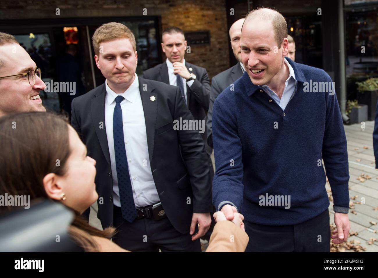 Warsaw, Poland, 23/02/2023, Prince William greets and talks to Ukrainians and his Polish fans during his visit in Warsaw. Britain's Prince William has made unannounced two-day visit to Poland that has been kept tightly under wraps due to security. During his visit, the Prince of Wales visited the British and Polish troops stationed next to the Ukrainian border, also met with Ukrainian refugees sheltering in Warsaw. On the second day of his visit Prince William talked to President Andrzej Duda at the presidential palace. In the final stop on his two-day visit, William went to a trendy food hall Stock Photo