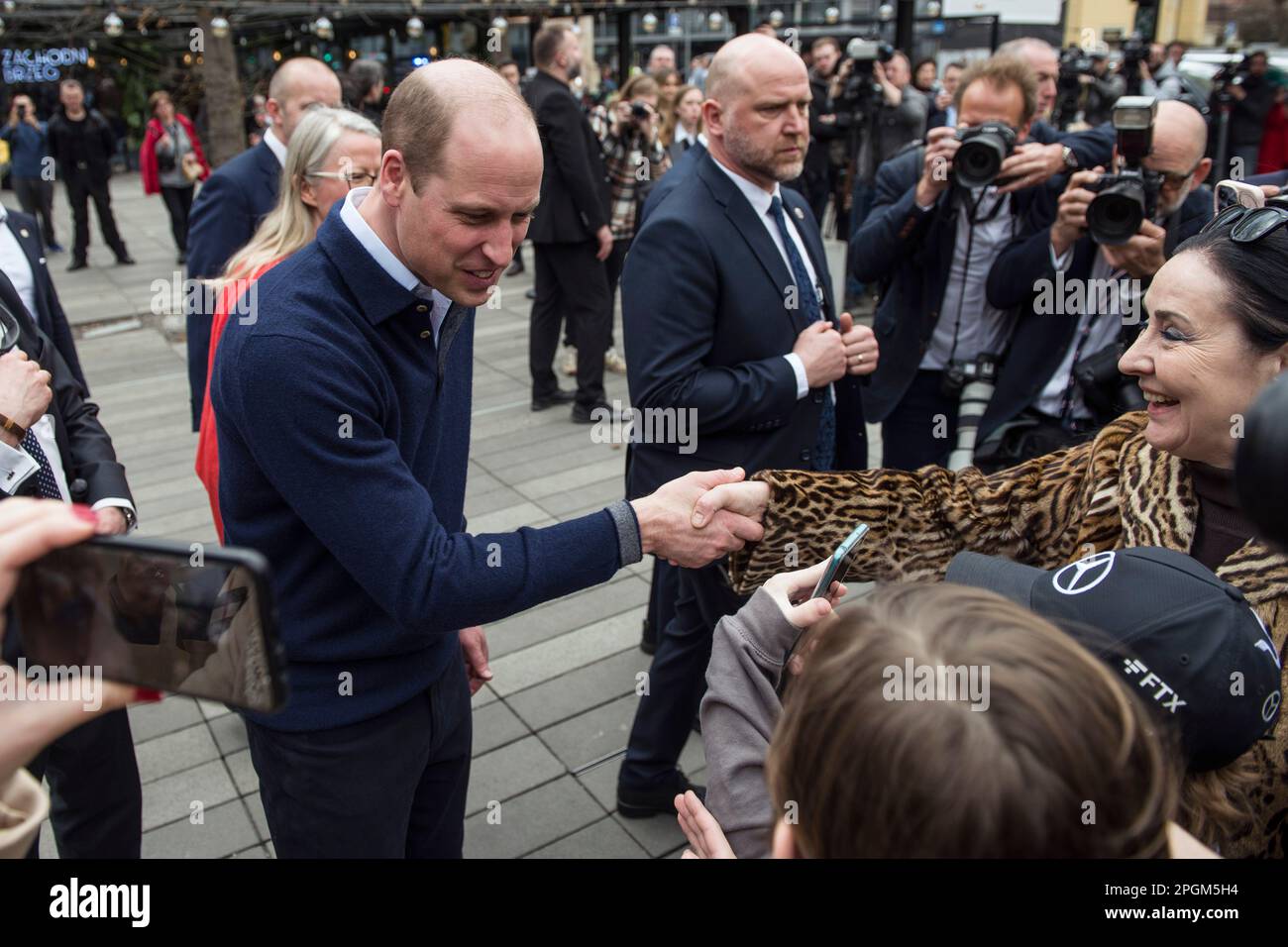 Warsaw, Poland, 23/02/2023, Prince William greets and talks to Ukrainians and his Polish fans during his visit in Warsaw. Britain's Prince William has made unannounced two-day visit to Poland that has been kept tightly under wraps due to security. During his visit, the Prince of Wales visited the British and Polish troops stationed next to the Ukrainian border, also met with Ukrainian refugees sheltering in Warsaw. On the second day of his visit Prince William talked to President Andrzej Duda at the presidential palace. In the final stop on his two-day visit, William went to a trendy food hall Stock Photo