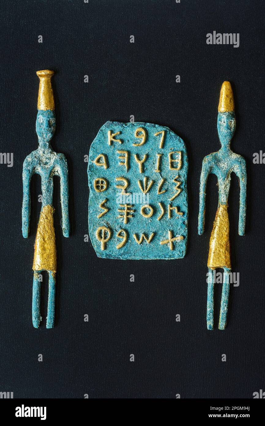 Reproduction of Phoenician alphabet with gilded letters on a stone