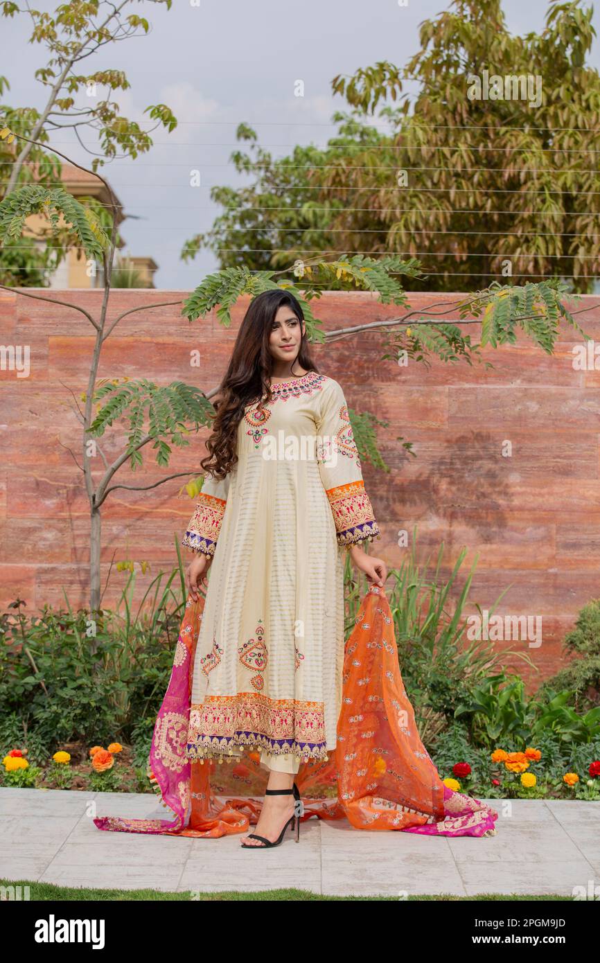 Female model posing outdoors wearing summer dress Indian Pakistani Asian  traditional salwar kameez Stock Photo - Alamy