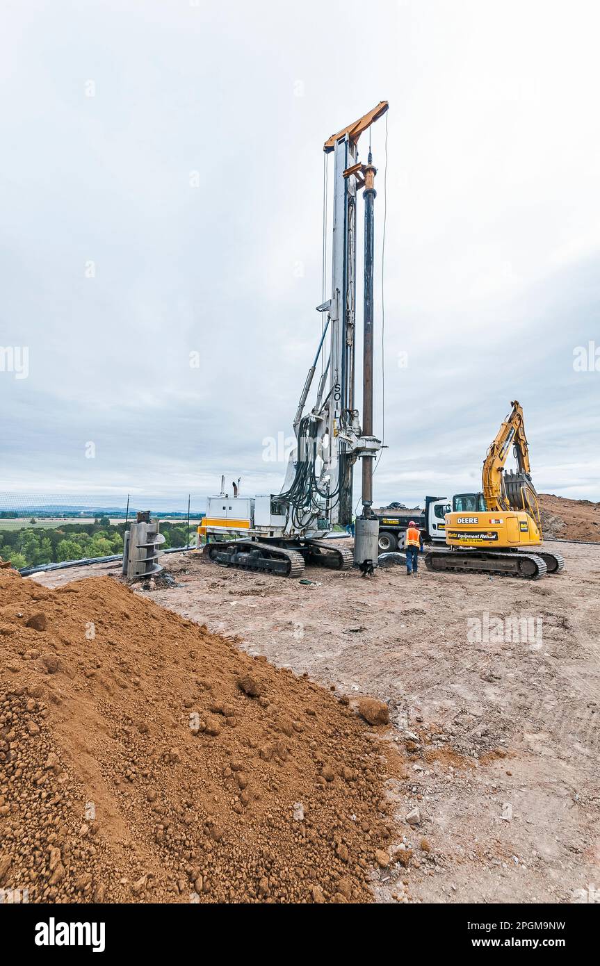 A power shovel and a methane gas well drilling rig at an active