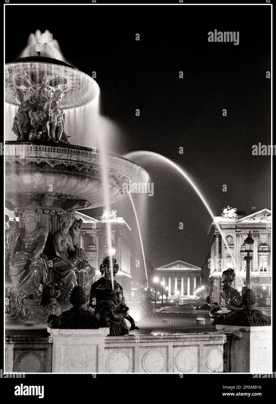 Place de la Concorde Fountain 1950 old historic Paris at night Fountain at Place de la Concorde Paris France The Fontaines de la Concorde are two monumental fountains located in the Place de la Concorde in the center of Paris. They were designed by Jacques Ignace Hittorff, and completed in 1840 during the reign of King Louis-Philippe B&W time exposure Paris France Stock Photo