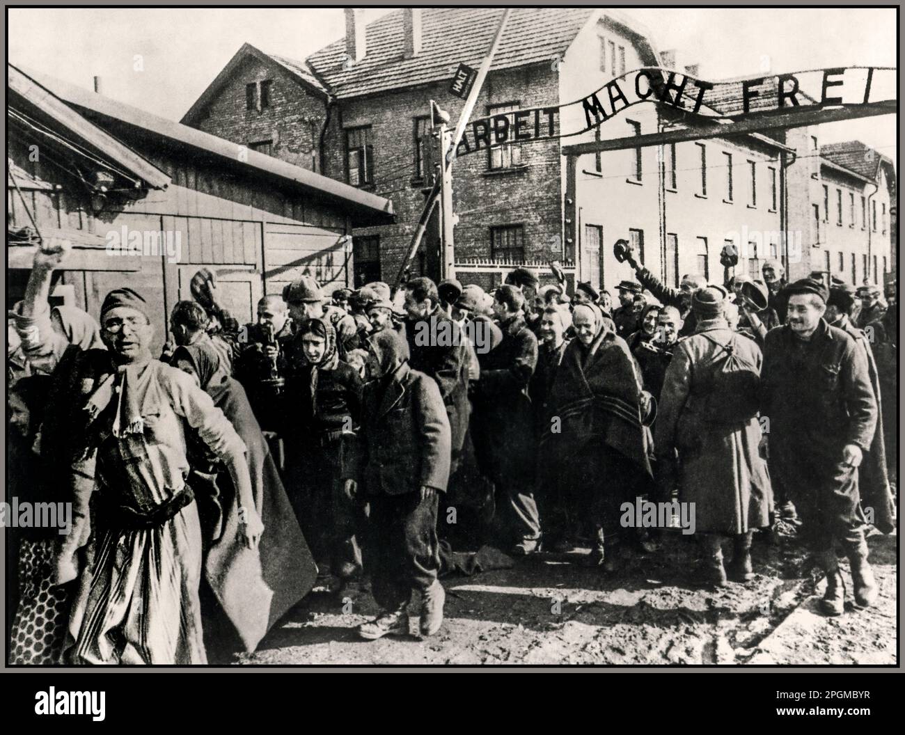 Auschwitz-Birkenau prisoners liberation by Soviet troops 26th January 1945, behind the infamous Nazi extermination & concentration camp entrance sign ARBEIT MACHT FREI. Work sets you free. WW2 World War II Second World War Occupied Poland Stock Photo