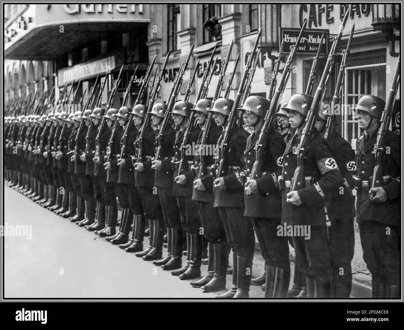 Leibstandarte SS Adolf Hitler SS-Stabswache at attention wearing swastika armbands and jackboots 1935, a select unit of Adolf Hitler's personal guard, welcoming the Minister of Foreign Affairs of Poland, Józef Beck, in front of the station. The 1st SS Panzer Division Leibstandarte SS Adolf Hitler or SS Division Leibstandarte, abbreviated as LSSAH, began as Adolf Hitler's personal bodyguard unit, responsible for guarding the Führer's person, offices, and residences Event date: 1935-07 Place: Berlin Nazi Germany Stock Photo