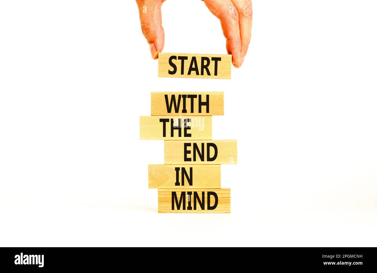 Start in end of mind symbol. Concept words Start with the end in mind on wooden blocks. Beautiful white table white background. Businessman hand. Busi Stock Photo