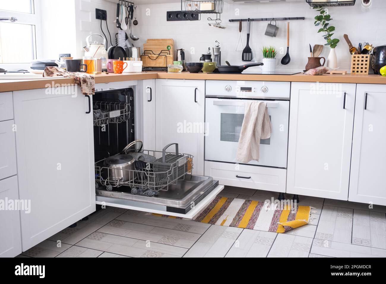 A mess in the kitchen, dirty dishes on the table, scattered things