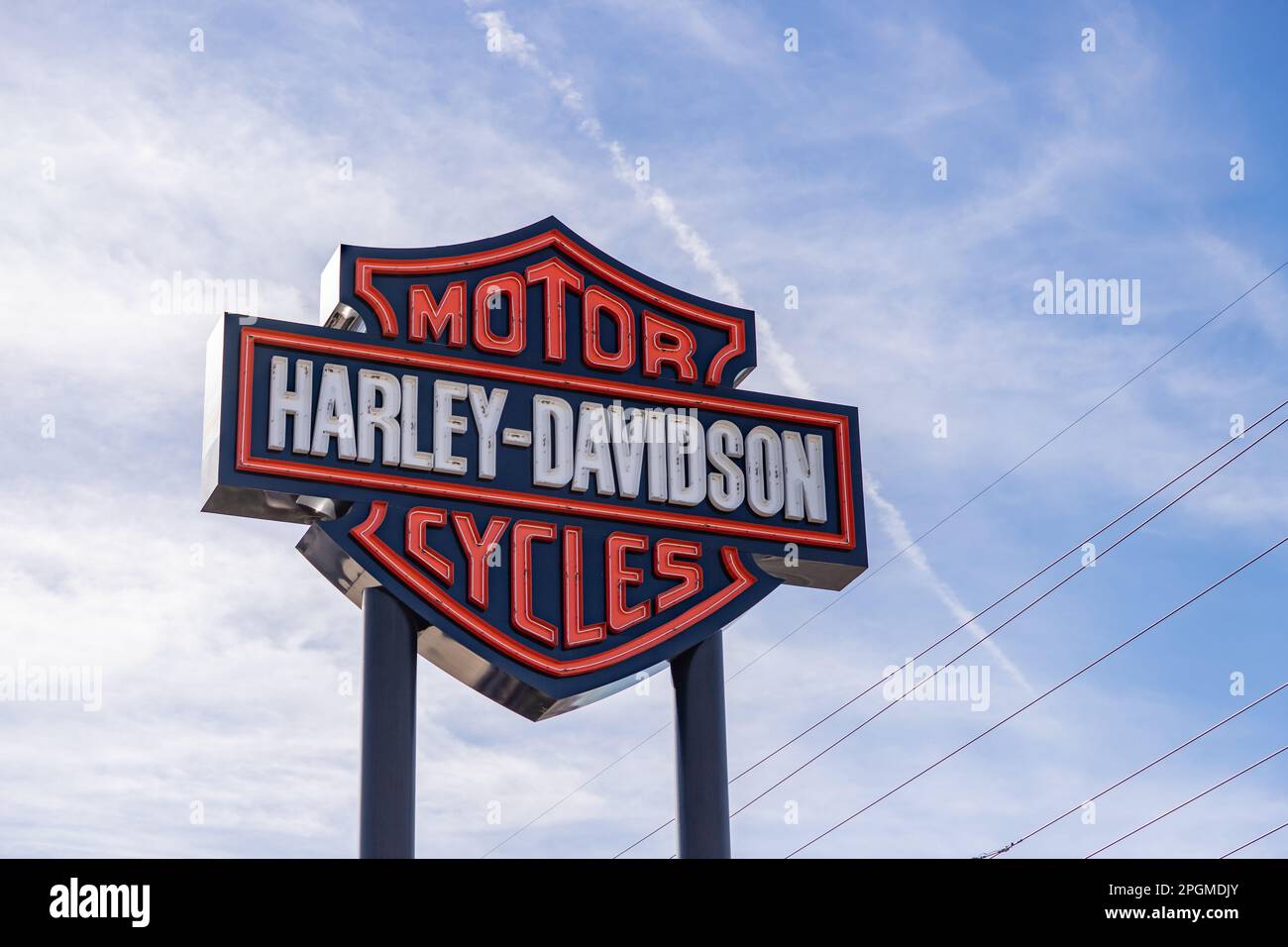 A picture of the Harley-Davidson logo against a blue sky. Stock Photo