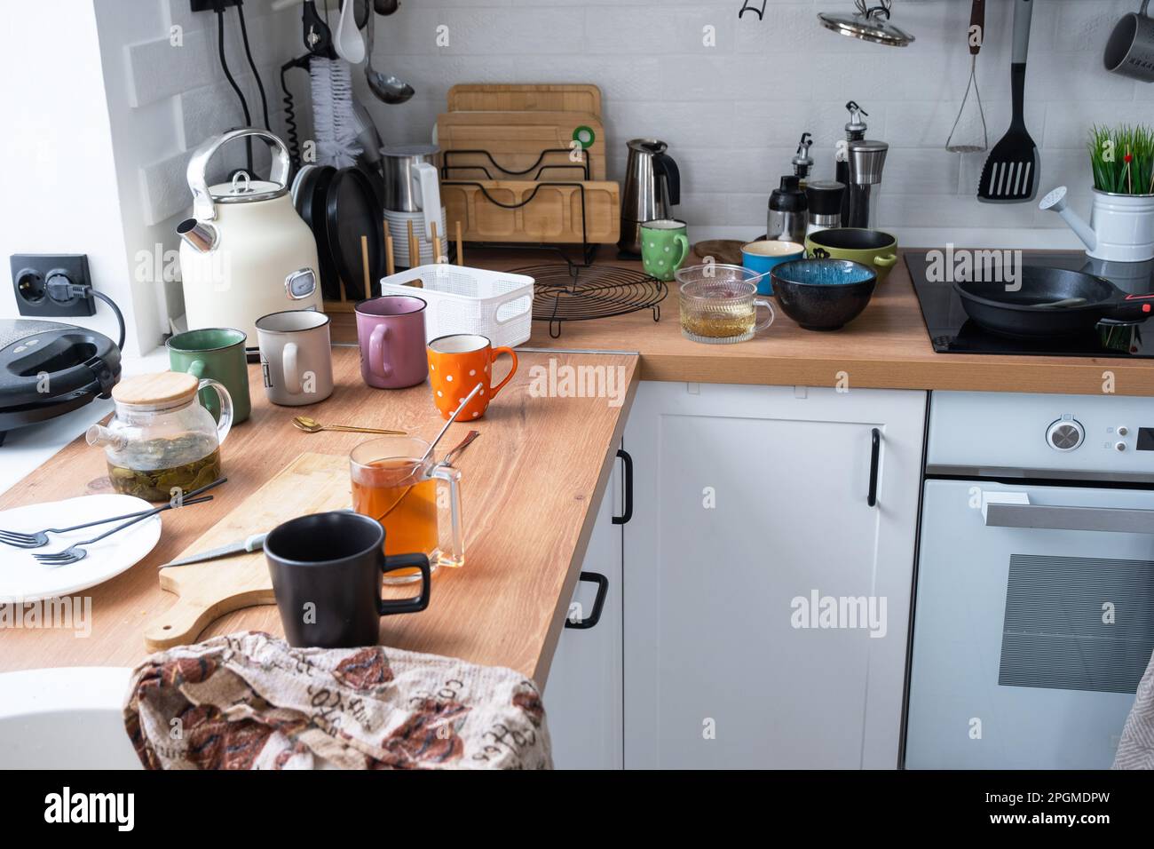 A mess in the kitchen, dirty dishes on the table, scattered things