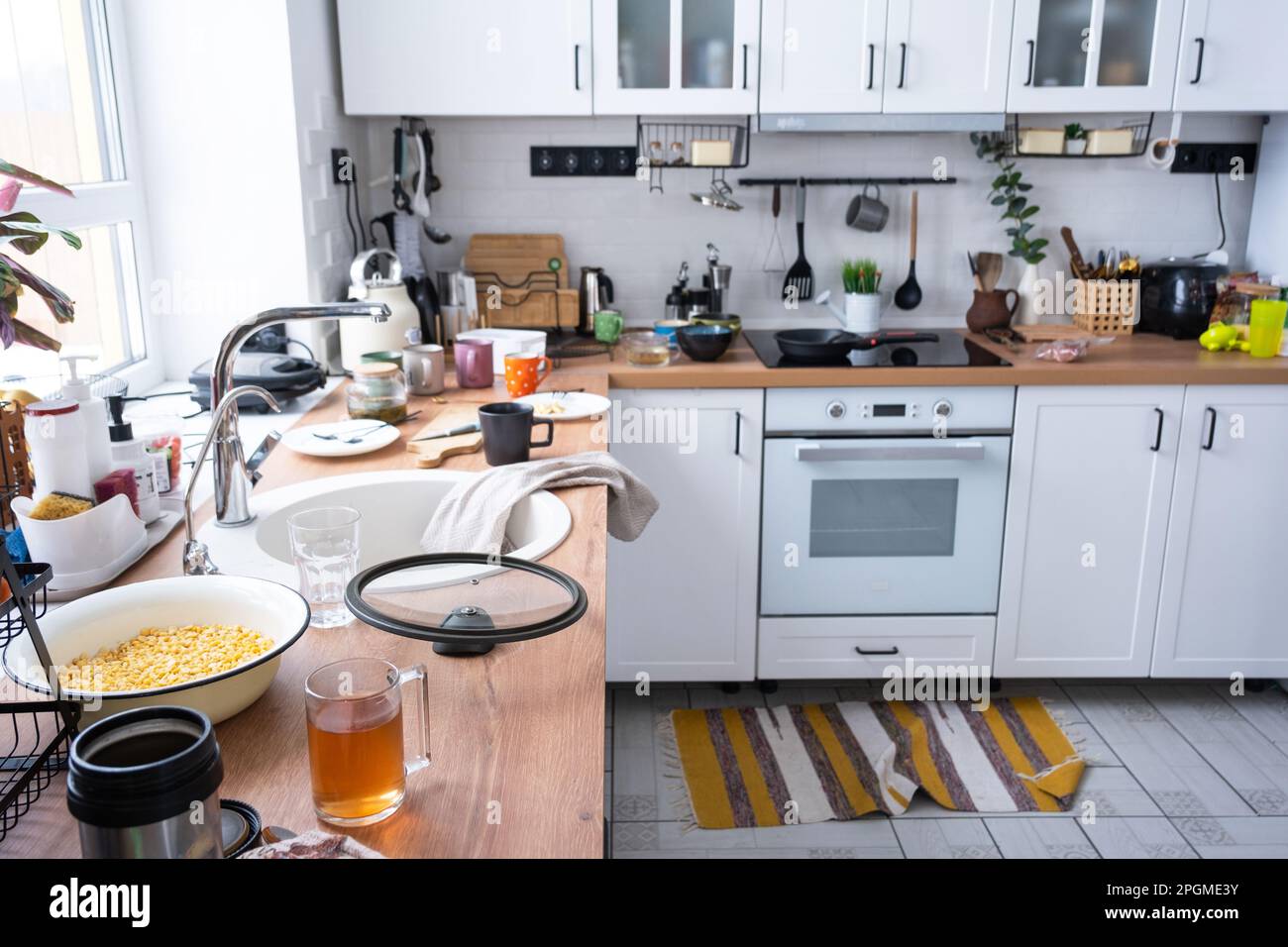 A mess in the kitchen, dirty dishes on the table, scattered things