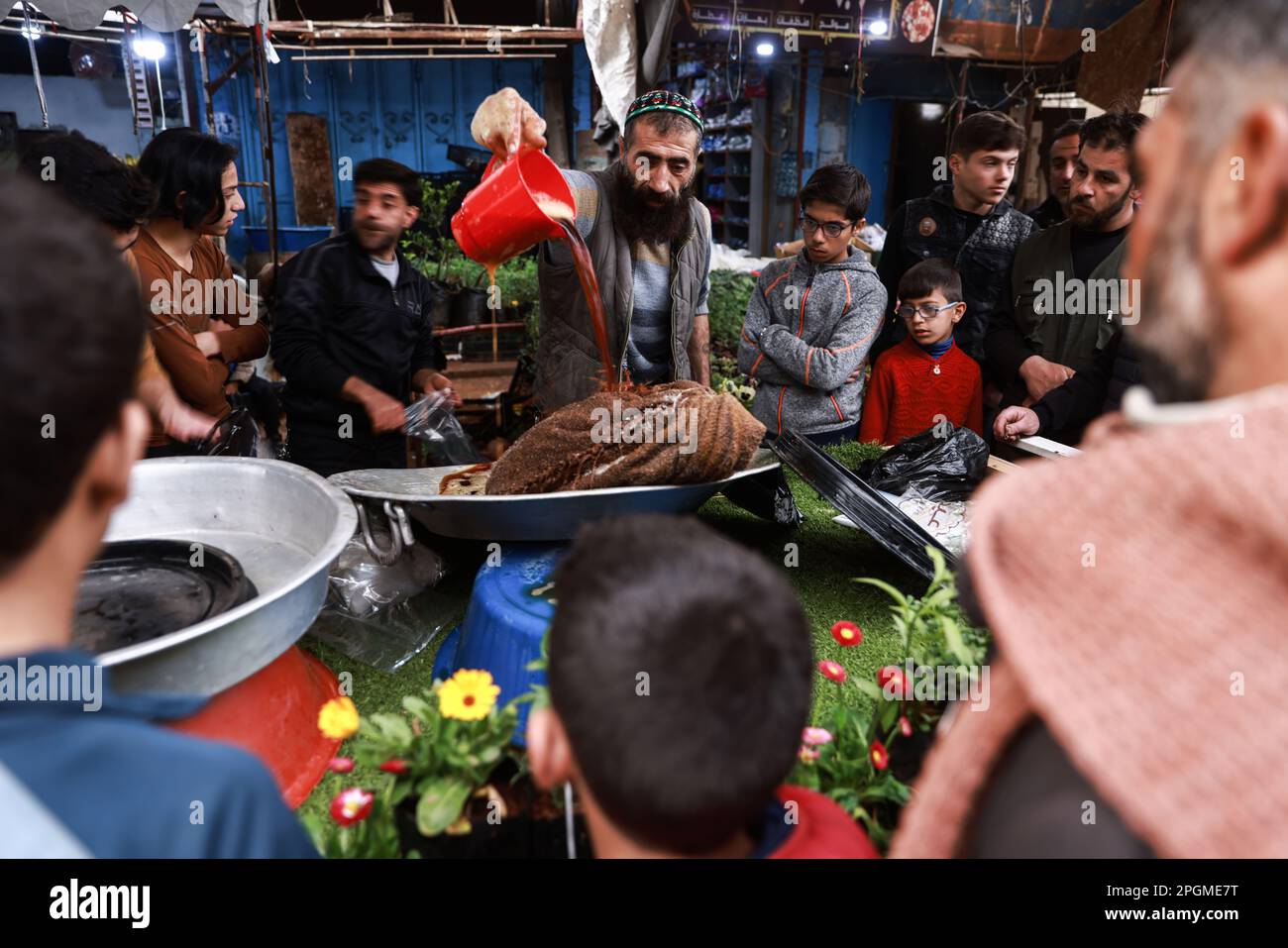 Ariha, Syria. 23rd Mar, 2023. A Syrian vendor prepares traditional