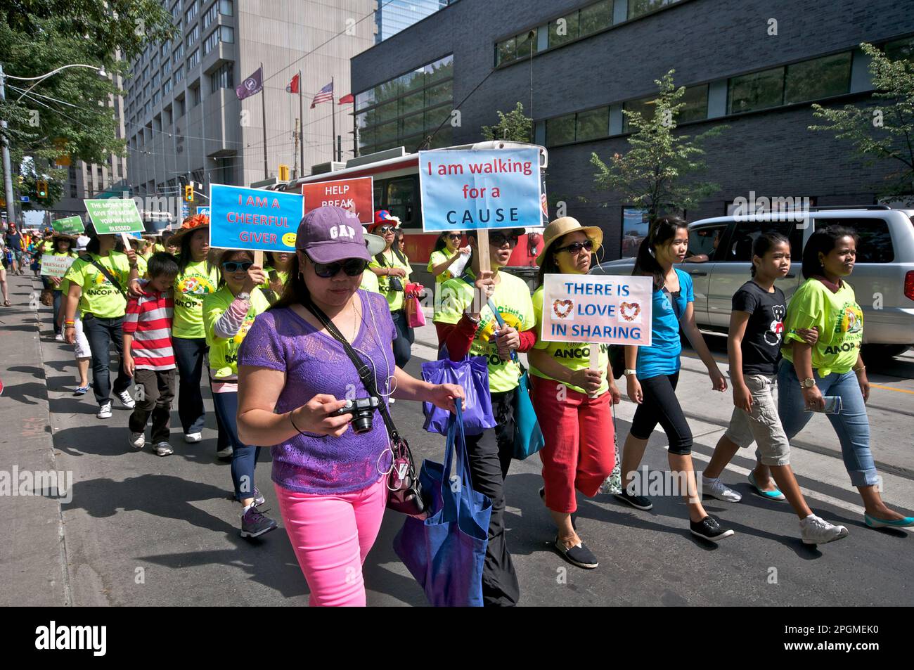 Toronto, Ontario, Canada - 08/25/2013: Protestors holding banners and placards against the Canadian government on the issue of sponsoring children in Stock Photo