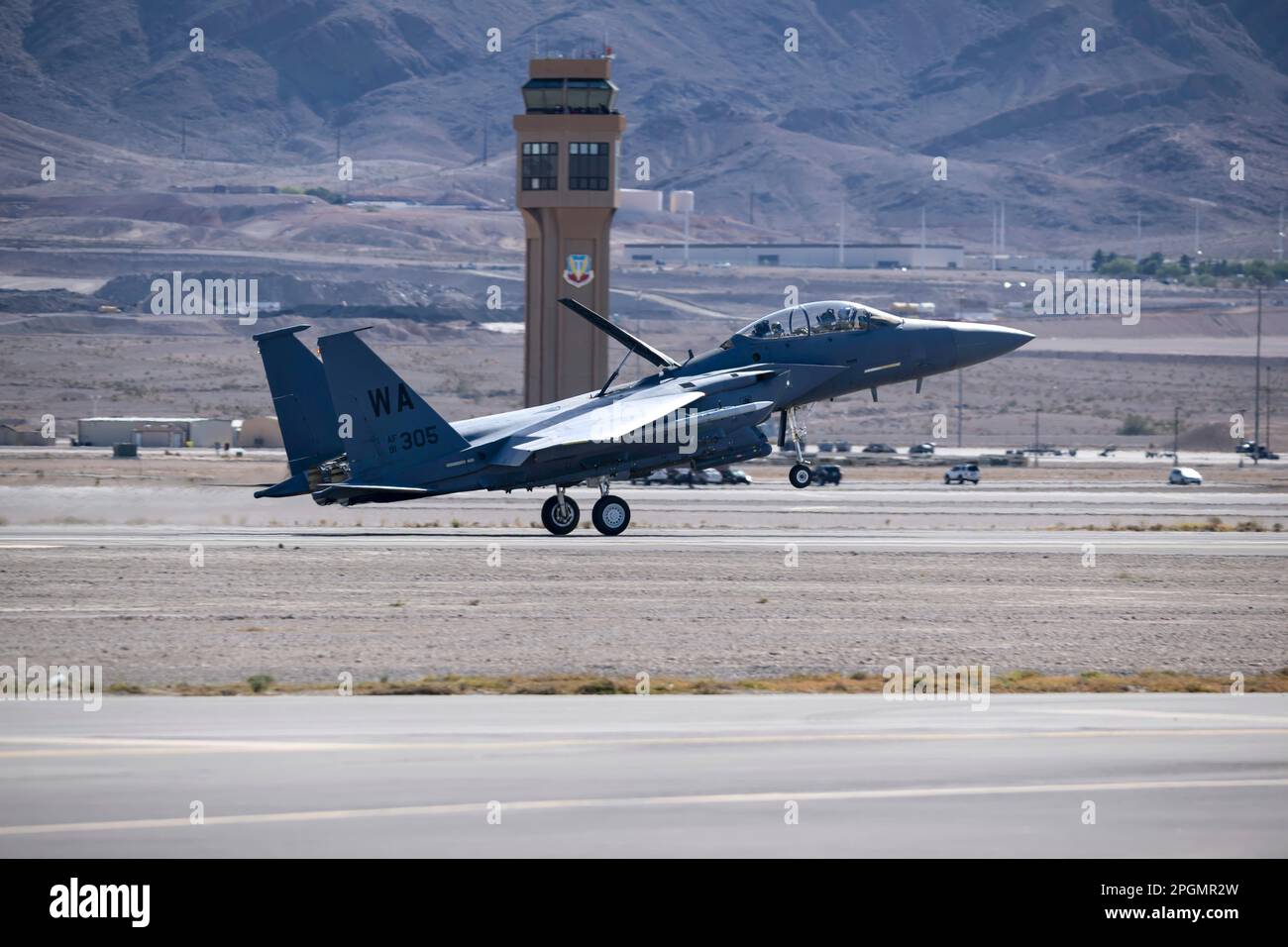 Las Vegas, NV - November 5, 2022: F-15 Strike Eagle Fighter Jet Lands in Front of The Control Tower at the Aviation Nation Airshow at Nellis AFB. Stock Photo