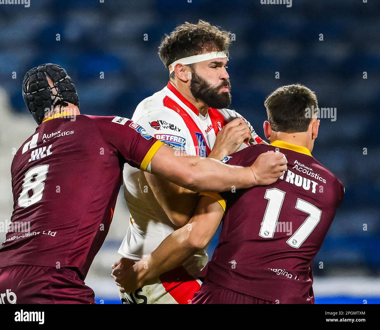 Alex Walmsley #8 of St Helens is tackled by Owen Trout #17 and Chris Hill #8 of Huddersfield Giants during the Betfred Super League Round 6 match Huddersfield Giants vs St Helens at John Smith's Stadium, Huddersfield, United Kingdom, 23rd March 2023  (Photo by Craig Thomas/News Images) Stock Photo