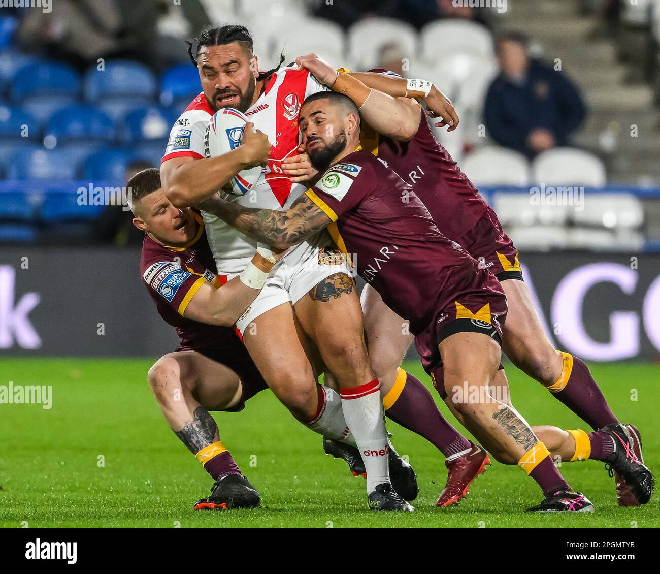 Konrad Hurrell #23 of St Helens is tackled by Luke Yates #13 and Nathan Peats #9 of Huddersfield Giants during the Betfred Super League Round 6 match Huddersfield Giants vs St Helens at John Smith's Stadium, Huddersfield, United Kingdom, 23rd March 2023  (Photo by Craig Thomas/News Images) Stock Photo