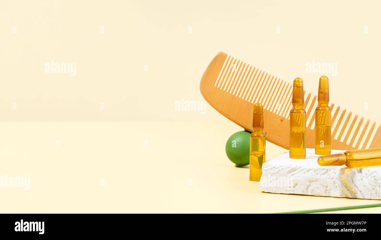 Cosmetic ampoules with serum for hair growth, restoration. Hair comb
