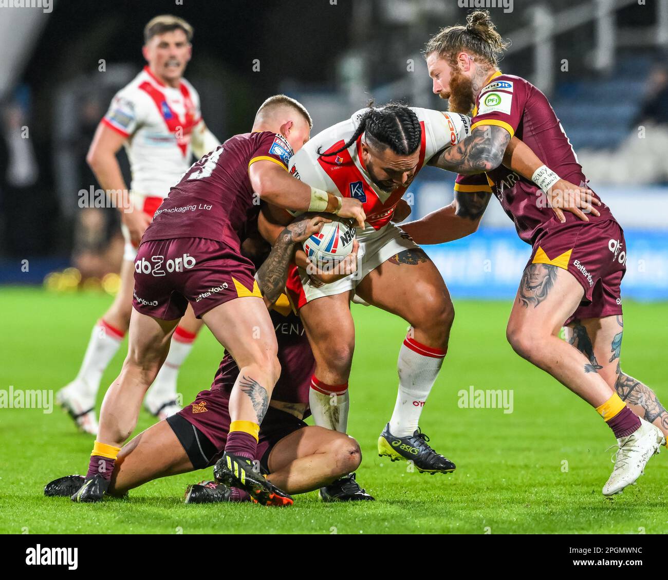 Konrad Hurrell #23 of St Helens is tackled by Chris McQueen #12 and Luke Yates #13 of Huddersfield Giants  during the Betfred Super League Round 6 match Huddersfield Giants vs St Helens at John Smith's Stadium, Huddersfield, United Kingdom, 23rd March 2023  (Photo by Craig Thomas/News Images) Stock Photo