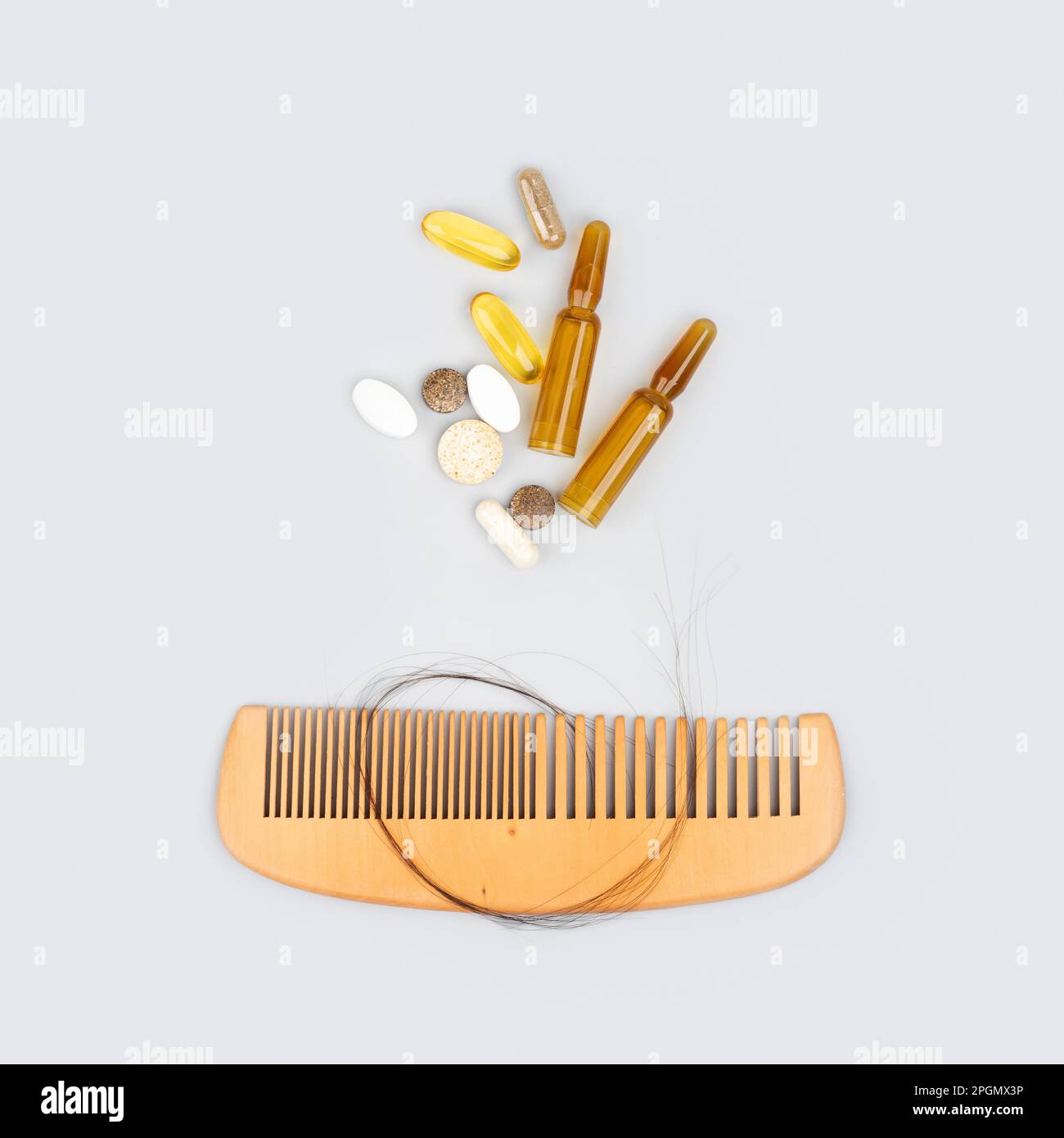 Cosmetic ampoules with serum and vitamins for hair growth, restoration beauty hair. Wooden comb