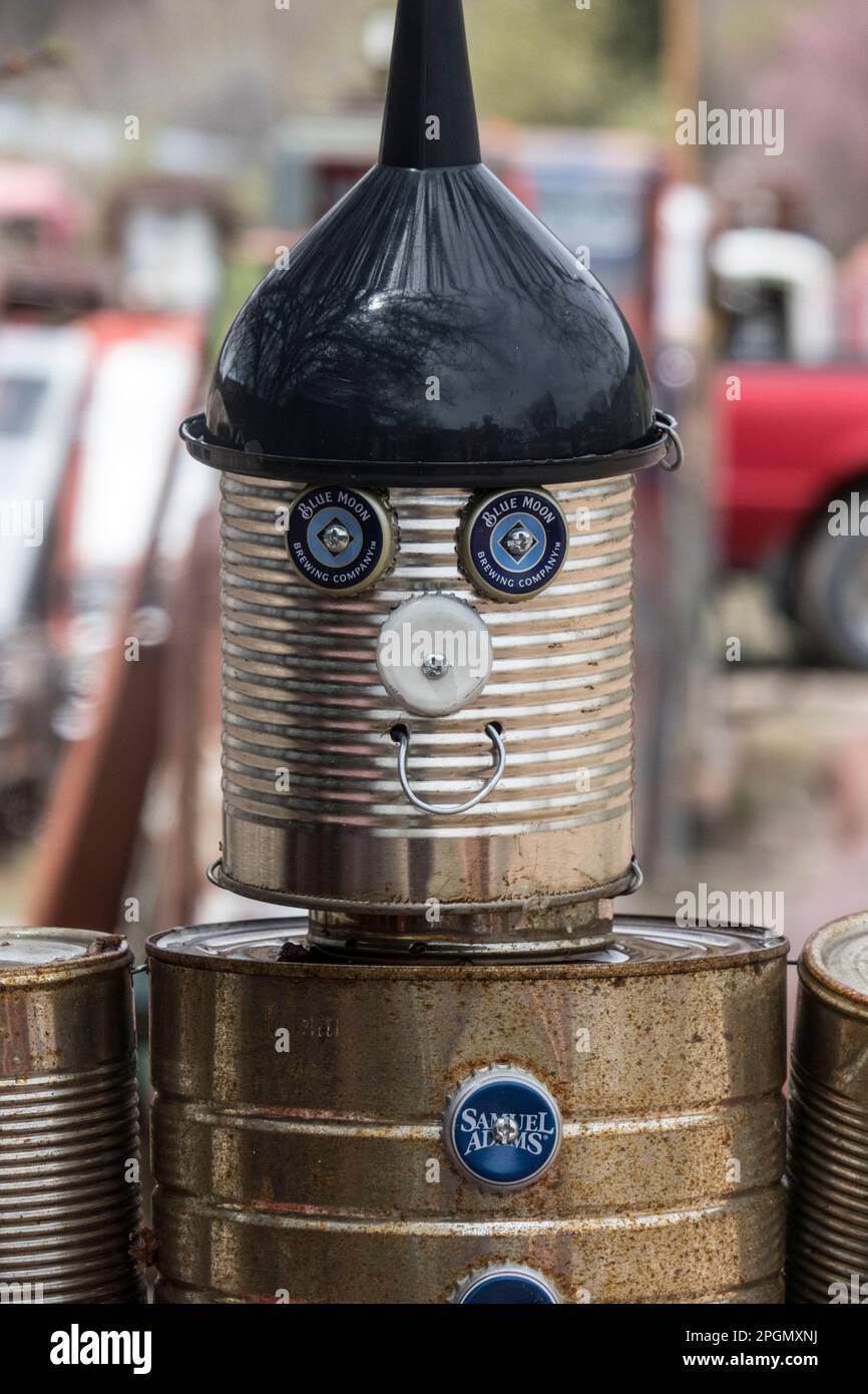 Junk sculpture made from old tin cans on display add a roadside stand