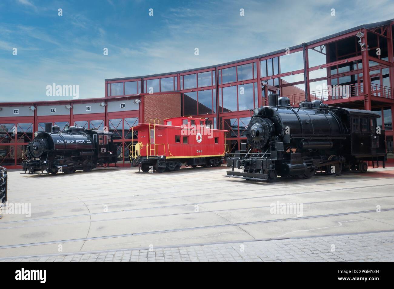Restored steam locomotives and a red caboose seen at the Steamtown national historic park in Scranton Pennsylvania Stock Photo