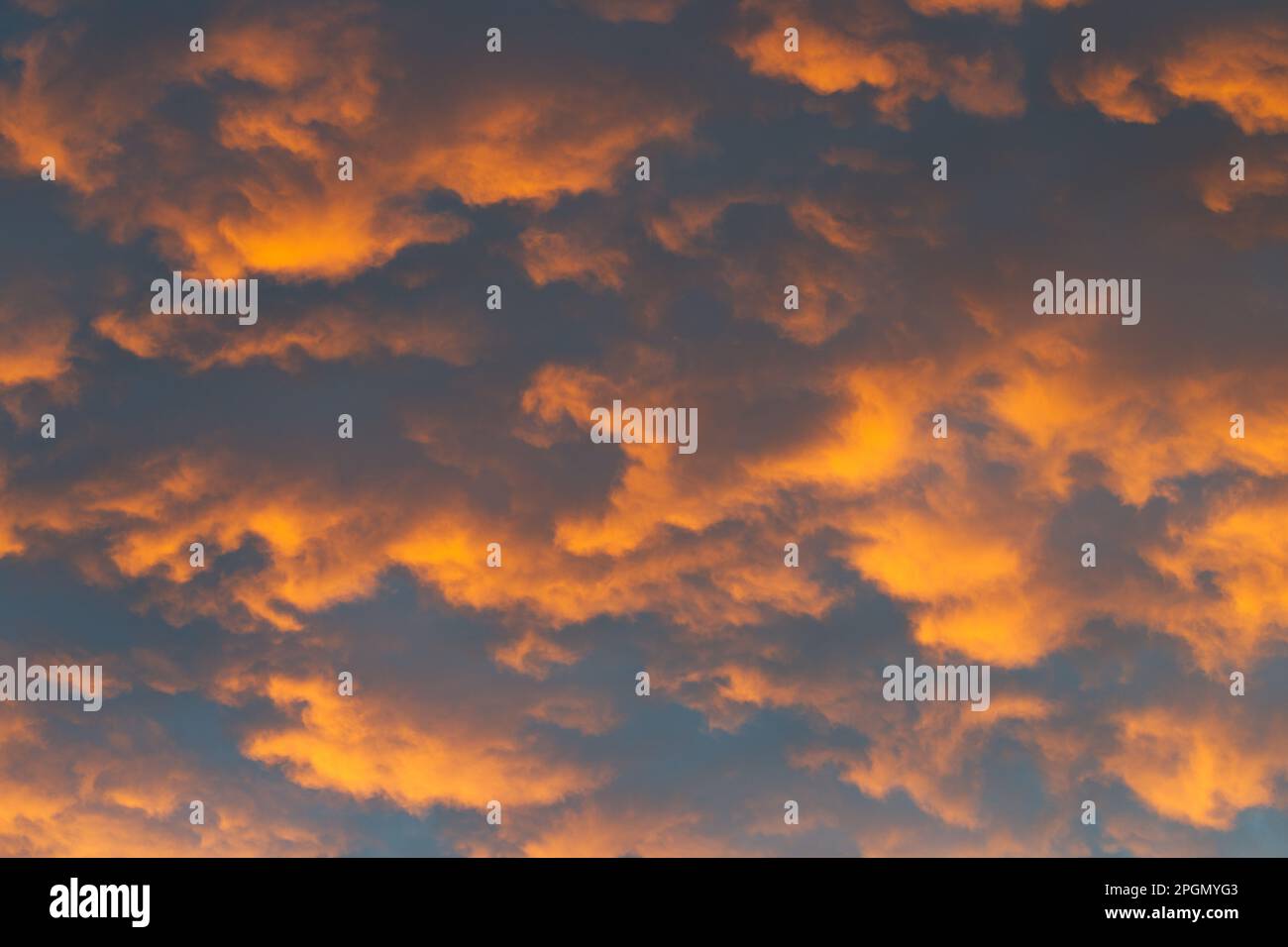 Orange abstract background sky with clouds patterns in late afternoon light, Victoria, Australia. Stock Photo