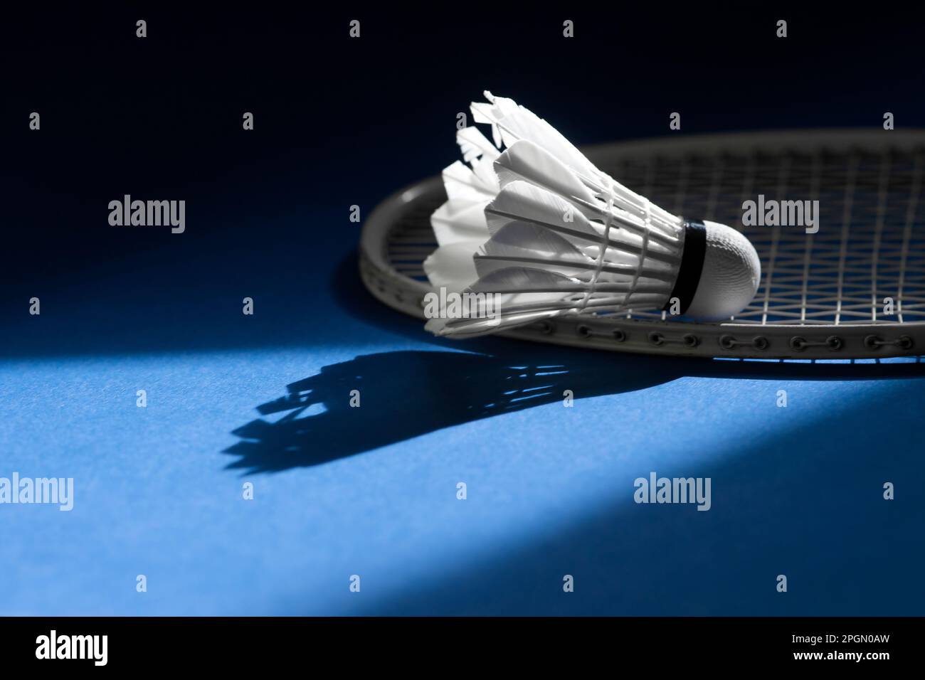 Badminton racket and shuttlecock on blue color background. Horizontal