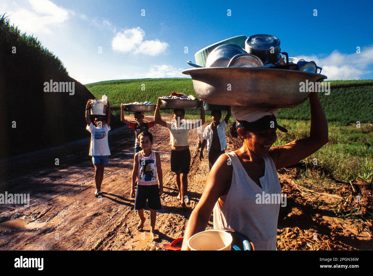 Daily life in countryside Northeastern Brazil, Family takes the dishes to be washed in the river. Palmares, Pernambuco State. Stock Photo