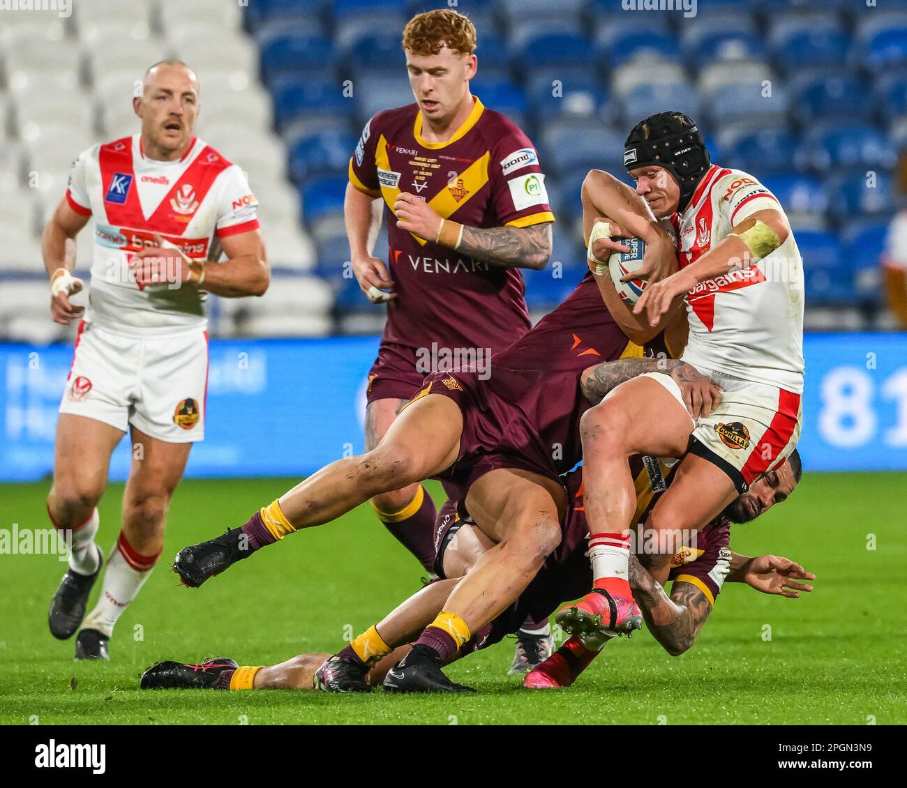 Jonny Lomax #6 of St Helens is tackled by Nathan Peats #9 and Owen Trout #17 of Huddersfield Giants during the Betfred Super League Round 6 match Huddersfield Giants vs St Helens at John Smith's Stadium, Huddersfield, United Kingdom, 23rd March 2023  (Photo by Craig Thomas/News Images) Stock Photo