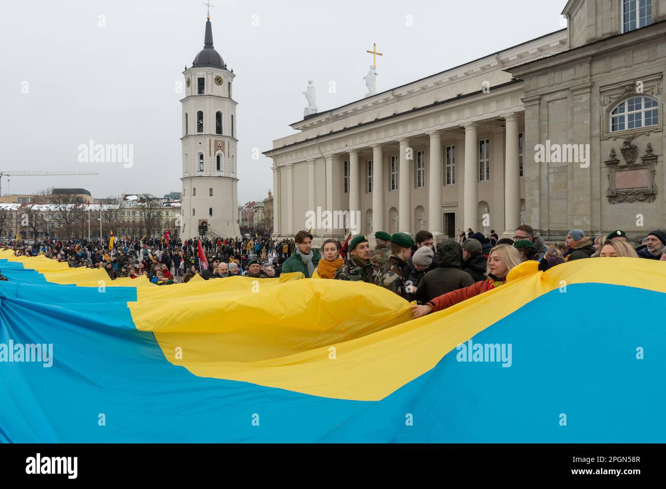 Vilnius Lithuania - March 11 2023: Huge Ukrainian flag along the street in Vilnius, carried by people with Lithuanian and Ukrainian flags Stock Photo