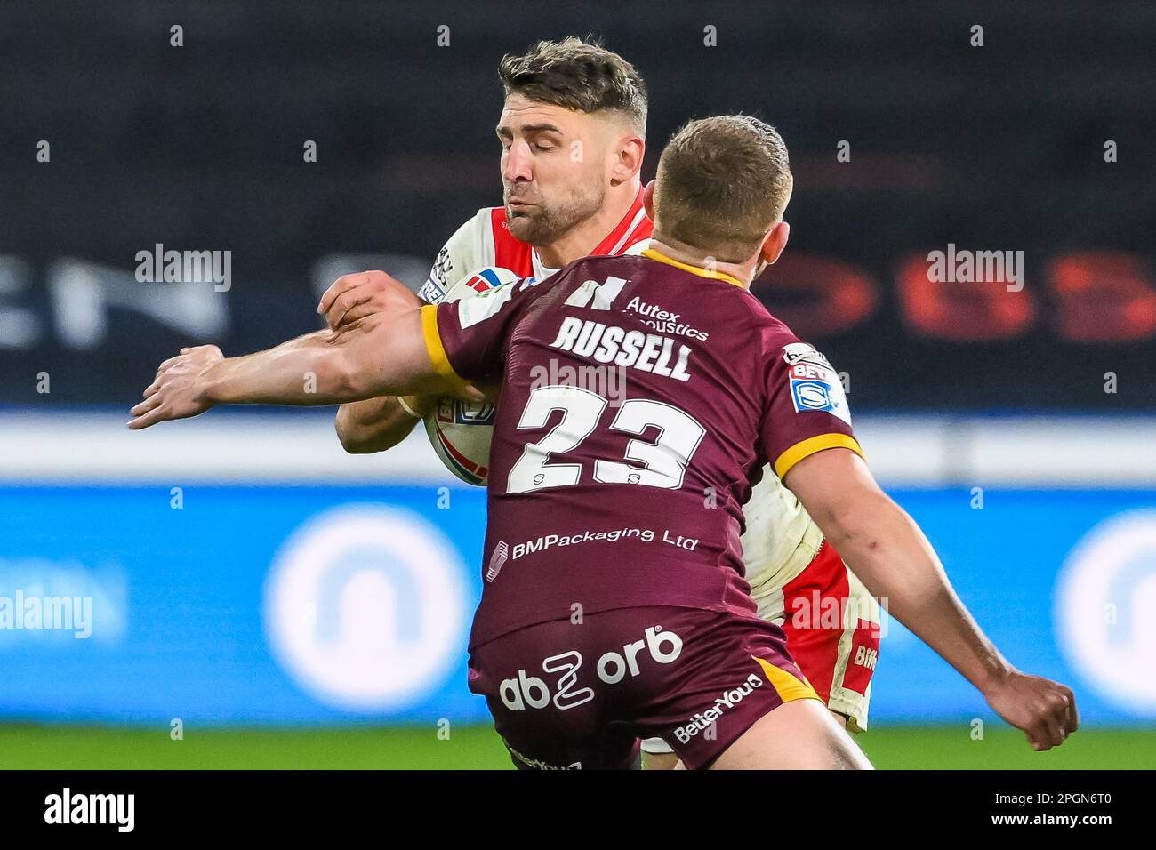 Tommy Makinson #2 of St Helens is tackled by Olly Russell #23 of Huddersfield Giants during the Betfred Super League Round 6 match Huddersfield Giants vs St Helens at John Smith's Stadium, Huddersfield, United Kingdom, 23rd March 2023  (Photo by Craig Thomas/News Images) Stock Photo