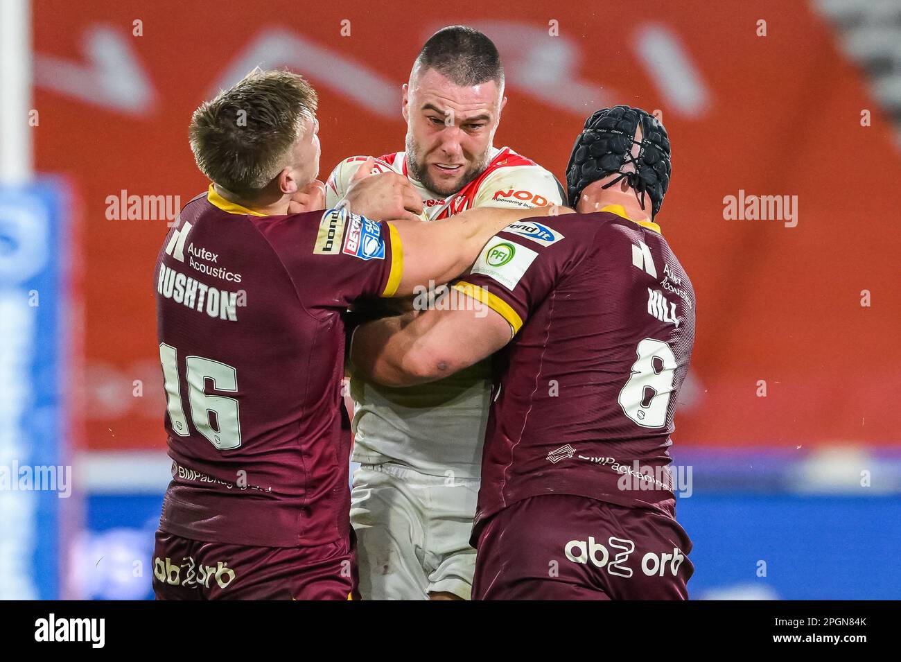 Curtis Sironen #16 of St Helens is tackled by Harry Rushton #16 and Chris Hill #8 of Huddersfield Giants during the Betfred Super League Round 6 match Huddersfield Giants vs St Helens at John Smith's Stadium, Huddersfield, United Kingdom, 23rd March 2023  (Photo by Craig Thomas/News Images) Stock Photo