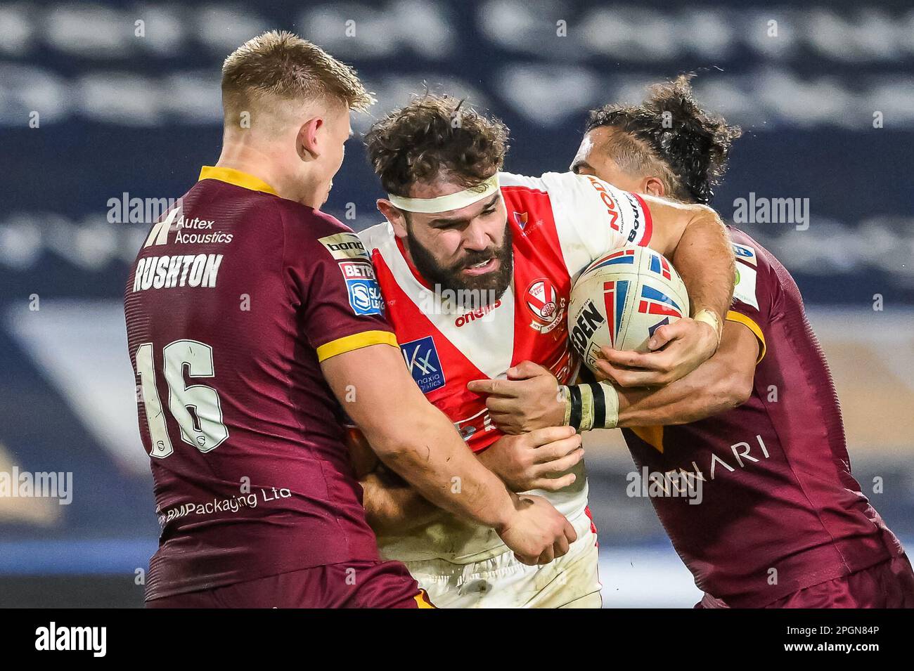 Alex Walmsley #8 of St Helens is tackled by Harry Rushton #16 and Ashton Golding #14 of Huddersfield Giants during the Betfred Super League Round 6 match Huddersfield Giants vs St Helens at John Smith's Stadium, Huddersfield, United Kingdom, 23rd March 2023  (Photo by Craig Thomas/News Images) Stock Photo