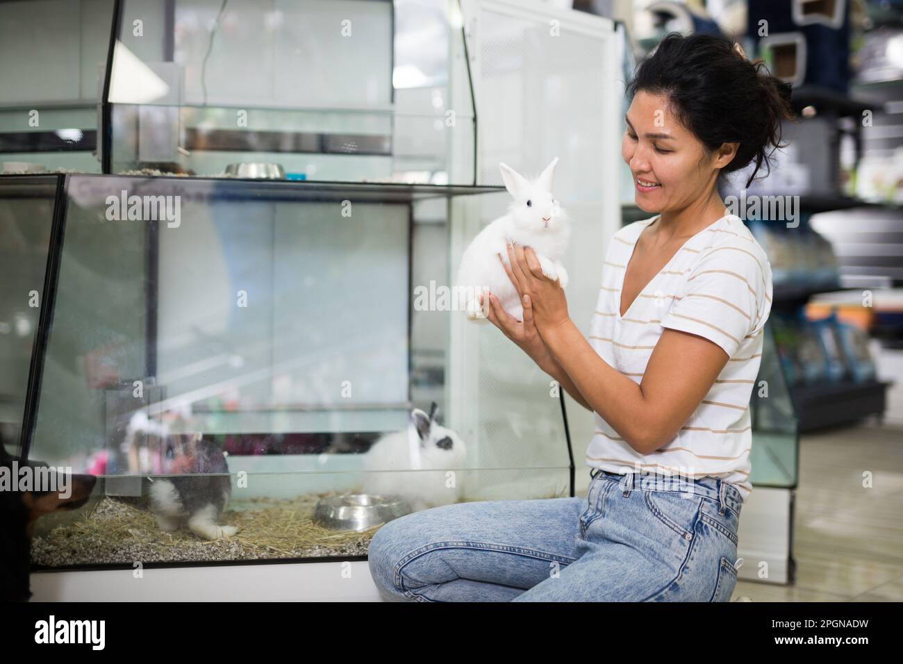 Oriental woman with rabbits in pet shop Stock Photo - Alamy