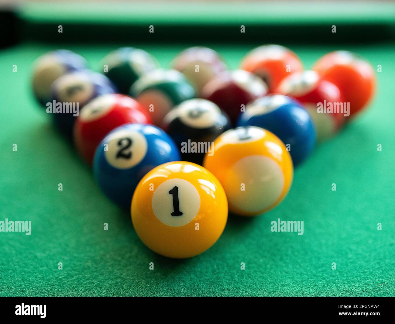 Billiard balls are in the triangle on the green table, selective focus. Concept of billiard, pool or snooker matches Stock Photo