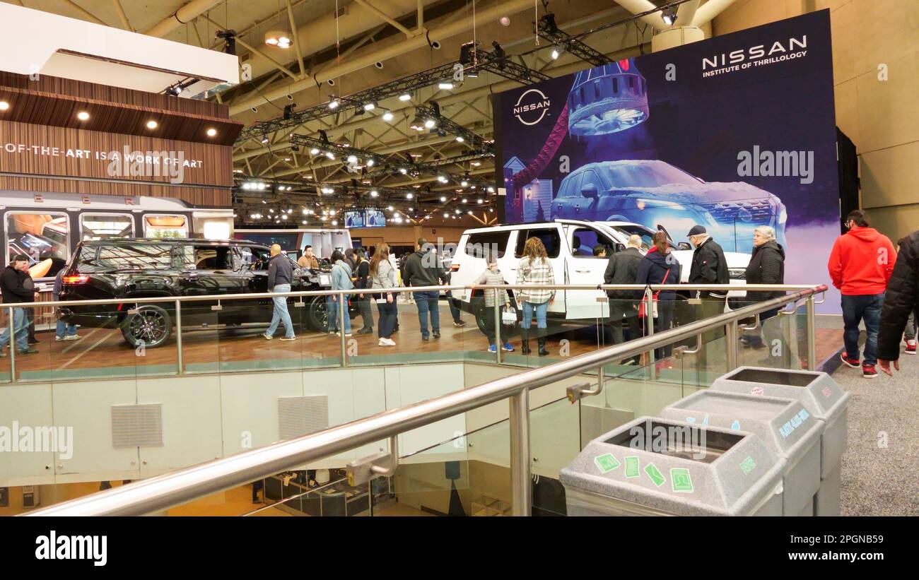 Crowds looking at new car models at Auto show. National Canadian Auto Show with many car brands. Toronto ON Canada Feb 19, 2023 Stock Photo