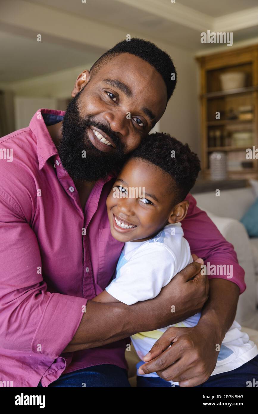 Portrait of happy african american father and son embracing and smiling ...