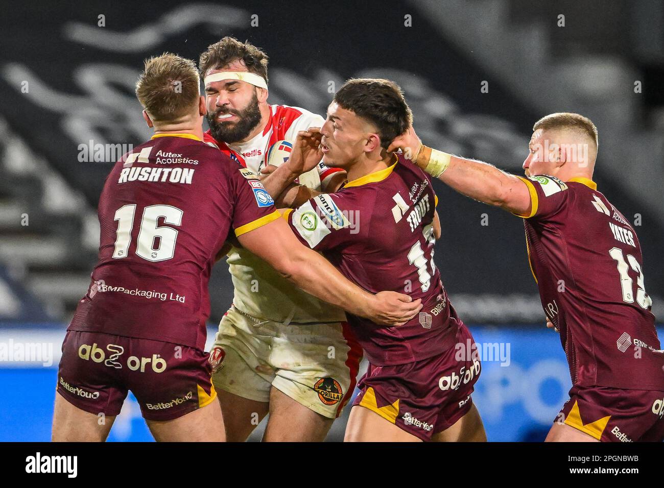 Alex Walmsley #8 of St Helens is tackled by Harry Rushton #16 and Owen Trout #17 of Huddersfield Giants during the Betfred Super League Round 6 match Huddersfield Giants vs St Helens at John Smith's Stadium, Huddersfield, United Kingdom, 23rd March 2023  (Photo by Craig Thomas/News Images) Stock Photo