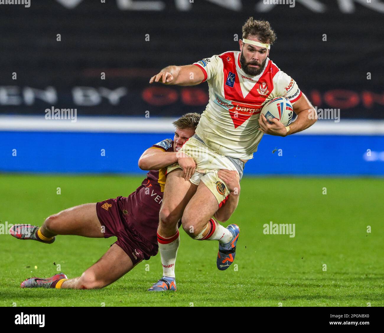 Alex Walmsley #8 of St Helens is tackled by Ashton Golding #14 of Huddersfield Giants  during the Betfred Super League Round 6 match Huddersfield Giants vs St Helens at John Smith's Stadium, Huddersfield, United Kingdom, 23rd March 2023  (Photo by Craig Thomas/News Images) Stock Photo