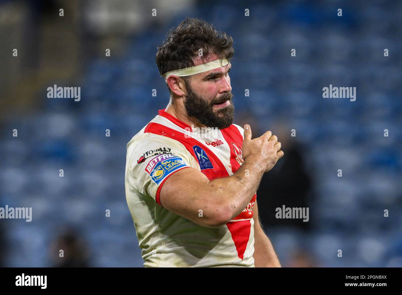 Alex Walmsley #8 of St Helens pats the st. Helens crest on his shirt to the fans at the end of the Betfred Super League Round 6 match Huddersfield Giants vs St Helens at John Smith's Stadium, Huddersfield, United Kingdom, 23rd March 2023  (Photo by Craig Thomas/News Images) Stock Photo