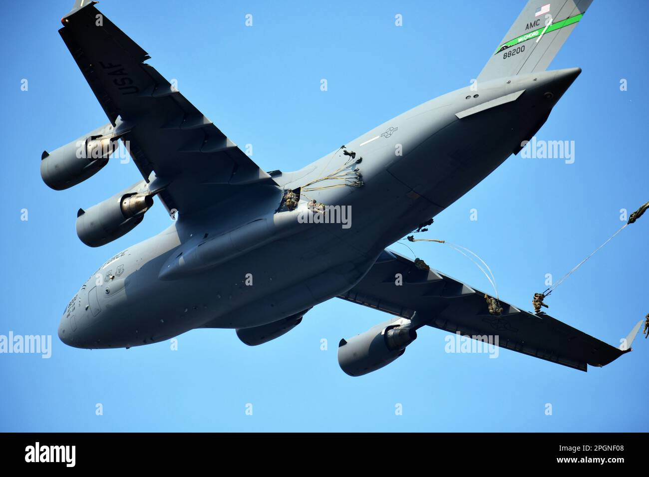 US Army Paratroopers assigned to 2nd Battalion, 503rd Parachute Infantry Regiment, 173rd Airborne Brigade, descend onto Juliet Drope Zone, after exiting a C-17 from 446th Airlift Wing, during an airborne operation in commemoration of the 20th anniversary of Operation Northern Delay, Pordenone, Italy on March 22, 2023. Operation Northern Delay occurred on 26 March 2003 as part of the 2003 invasion of Iraq. It involved dropping 1,000 paratroopers from the 173rd Airborne Brigade into Northern Iraq. It was the last large-scale combat parachute operation conducted by the U.S. military since Operati Stock Photo