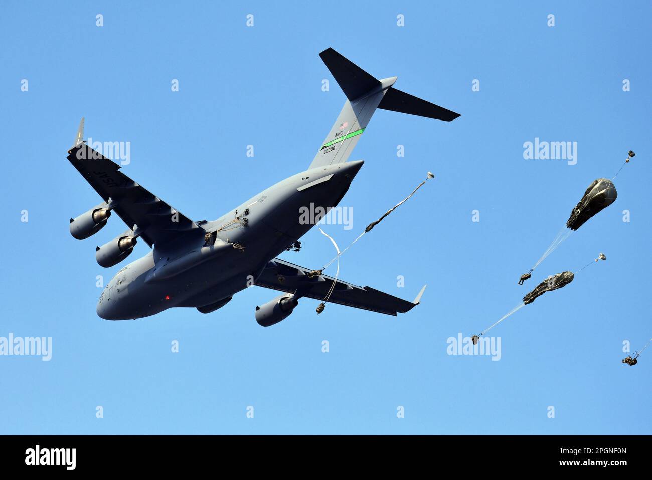 US Army Paratroopers assigned to 2nd Battalion, 503rd Parachute Infantry Regiment, 173rd Airborne Brigade, descend onto Juliet Drope Zone, after exiting a C-17 from 446th Airlift Wing during an airborne operation in commemoration of the 20th anniversary of Operation Northern Delay, Pordenone, Italy on March 22, 2023. Operation Northern Delay occurred on 26 March 2003 as part of the 2003 invasion of Iraq. It involved dropping 1,000 paratroopers from the 173rd Airborne Brigade into Northern Iraq. It was the last large-scale combat parachute operation conducted by the U.S. military since Operatio Stock Photo