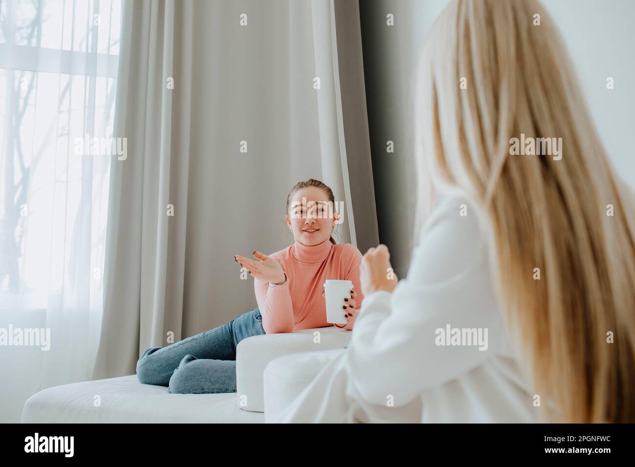 Patient having coffee and talking with psychologist in clinic Stock Photo