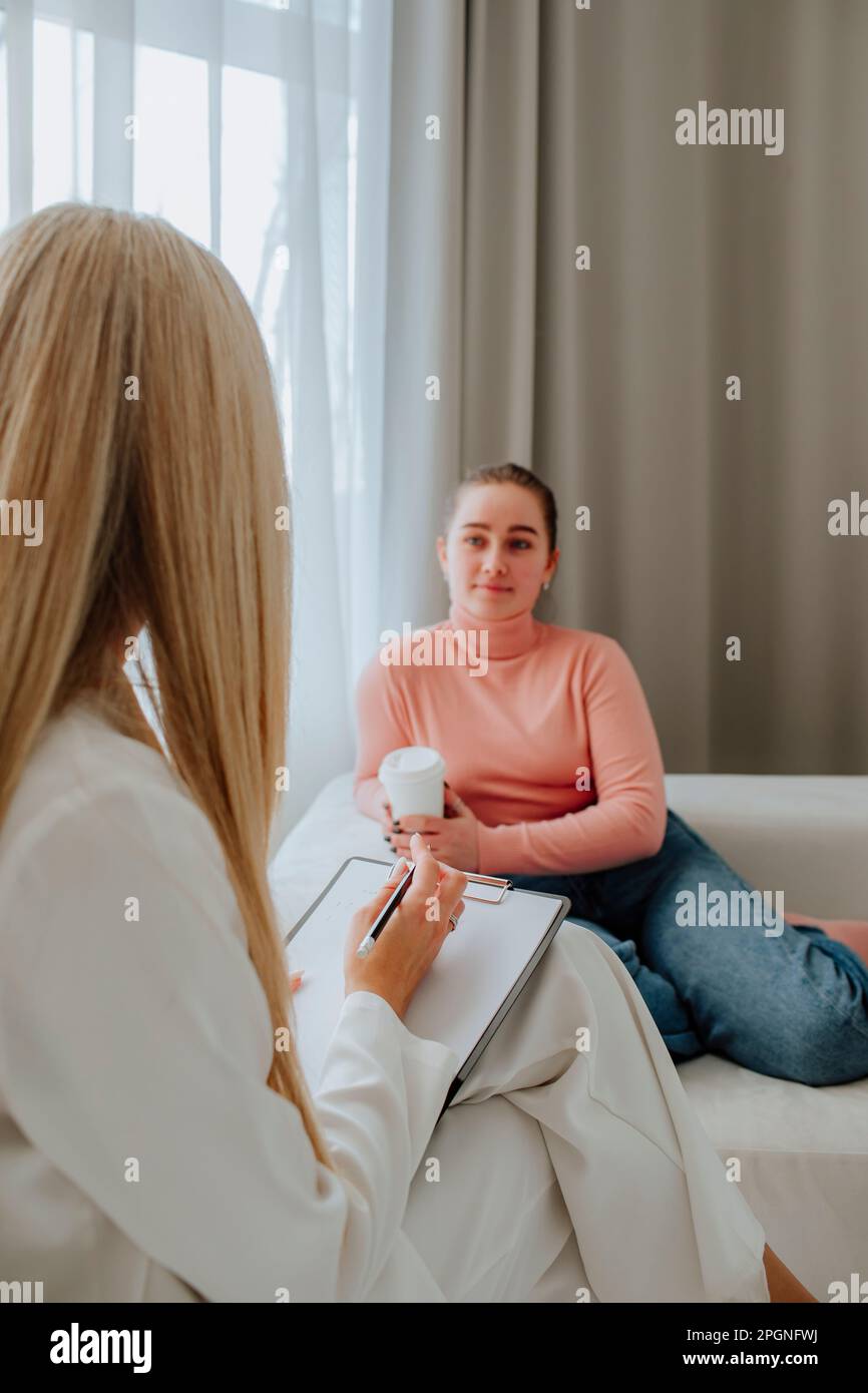 Patient looking at psychologist in clinic Stock Photo