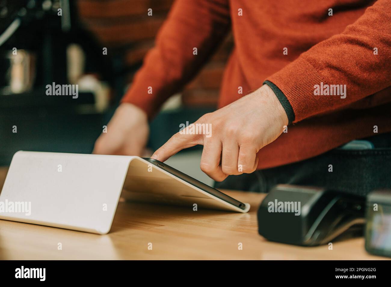 Cafe owner using tablet PC at cafe Stock Photo
