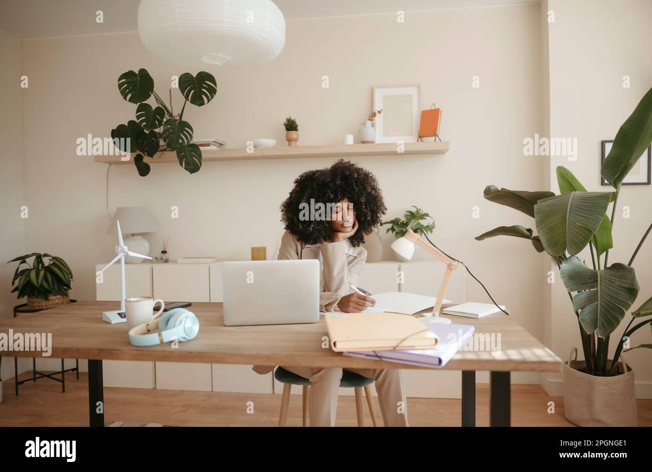 Young businesswoman taking notes in office Stock Photo
