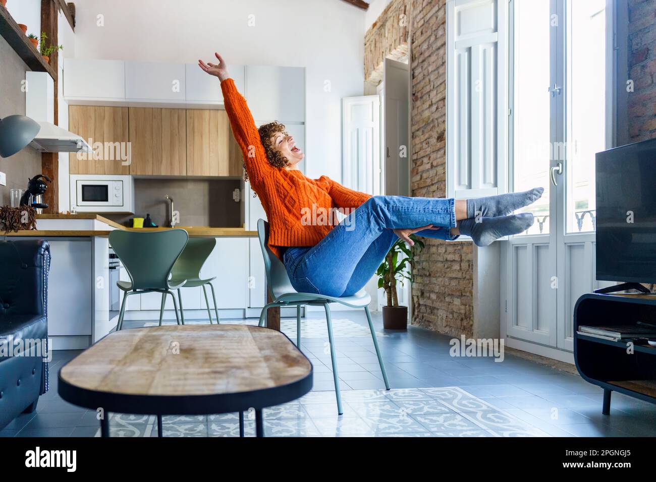 Modern woman sitting home on hi-res stock photography and images - Alamy