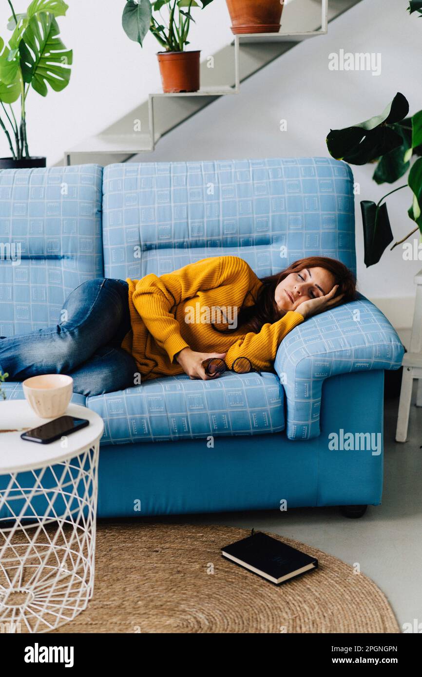 Woman relaxing on sofa at home hi-res stock photography and images - Alamy