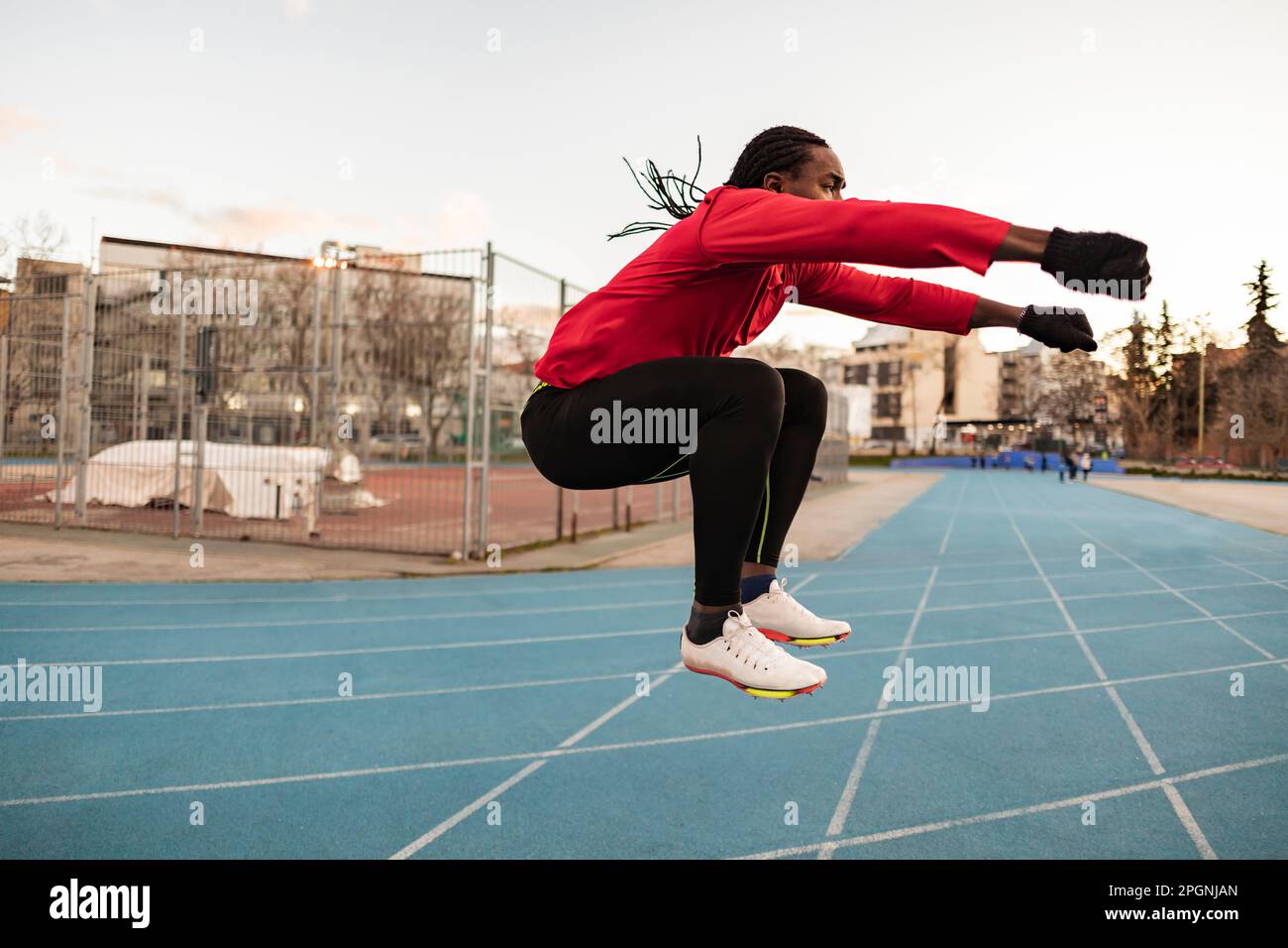 Athlete doing jumping exercise on sports track Stock Photo Alamy