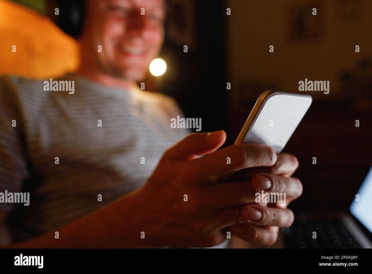 Hands of man using smart phone at home Stock Photo